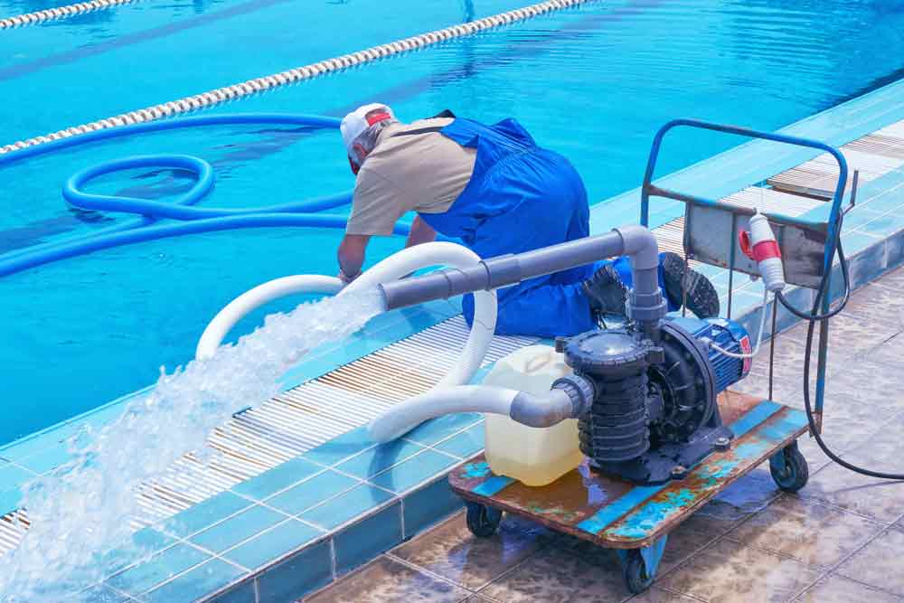 Worker Cleaning The Swimming Pool