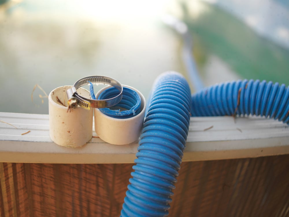 Pool Hose and Fittings at Pool Edge Showing Potential Leak Source