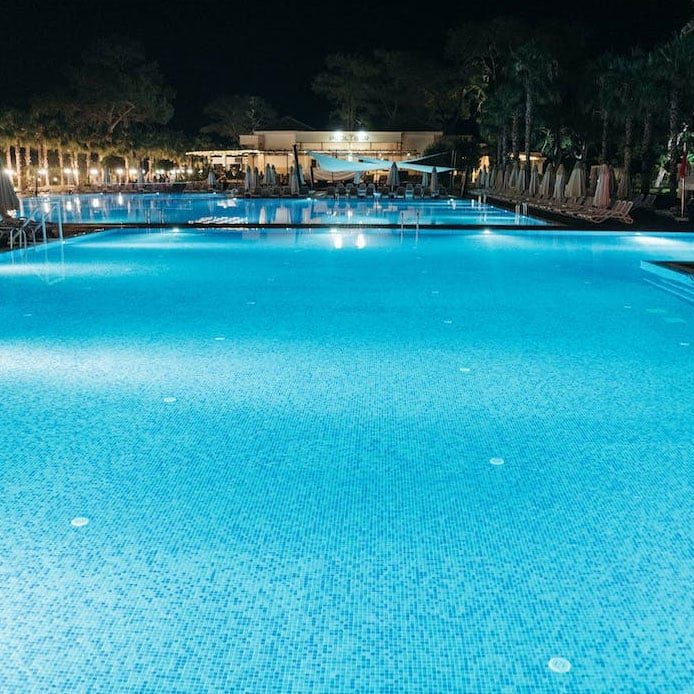 Swimming Pool At Night With Blue Water — Hi-Tech Pools & Spas In Yarawonga, NT