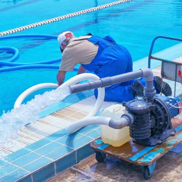 Worker Cleaning The Swimming Pool — Hi-Tech Pools & Spas In Yarawonga, NT
